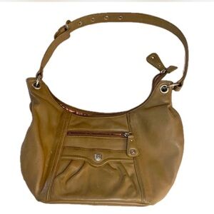 Stone Mountain embossed tan purse. Designer pink lining.